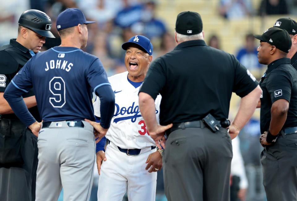 Dodgers manager Dave Roberts shares a laugh with Rays first base coach Michael Johns before a game last season.