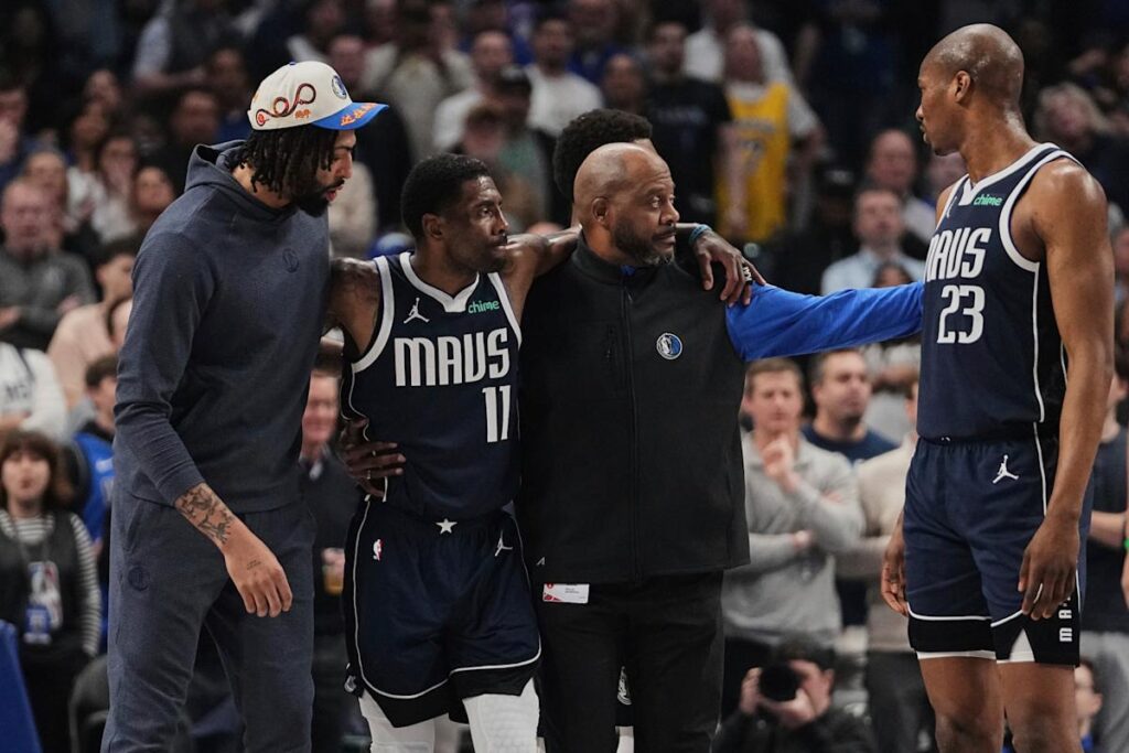 Mavericks star Kyrie Irving helped off the floor after awkward knee injury early in loss to Kings