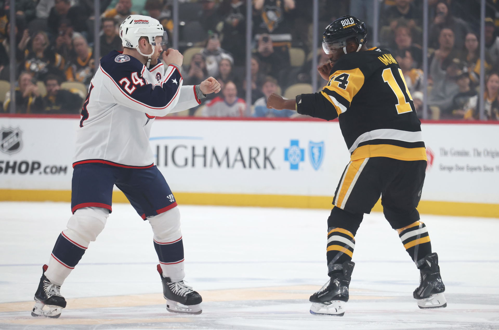 Mar 21, 2025; Pittsburgh, Pennsylvania, USA; Pittsburgh Penguins left wing Bokondji Imama (14) and Columbus Blue Jackets right wing Mathieu Olivier (24) fight during the first period at PPG Paints Arena. (Charles LeClaire-Imagn Images)