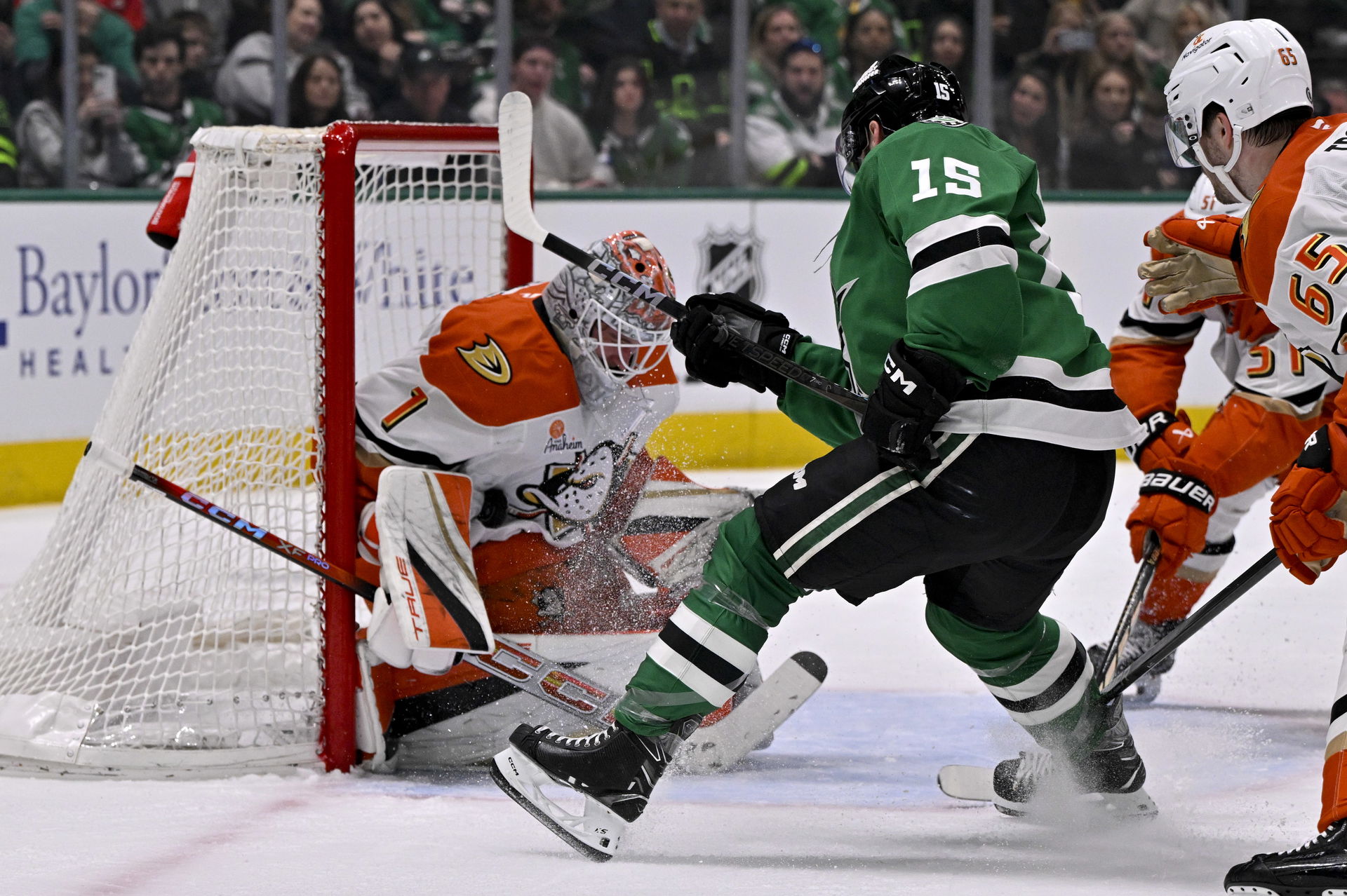 Mar 18, 2025; Dallas, Texas, USA; Anaheim Ducks goaltender Lukas Dostal (1) stops a shot by Dallas Stars center Colin Blackwell (15) during the second period at the American Airlines Center. Mandatory Credit: Jerome Miron-Imagn Images