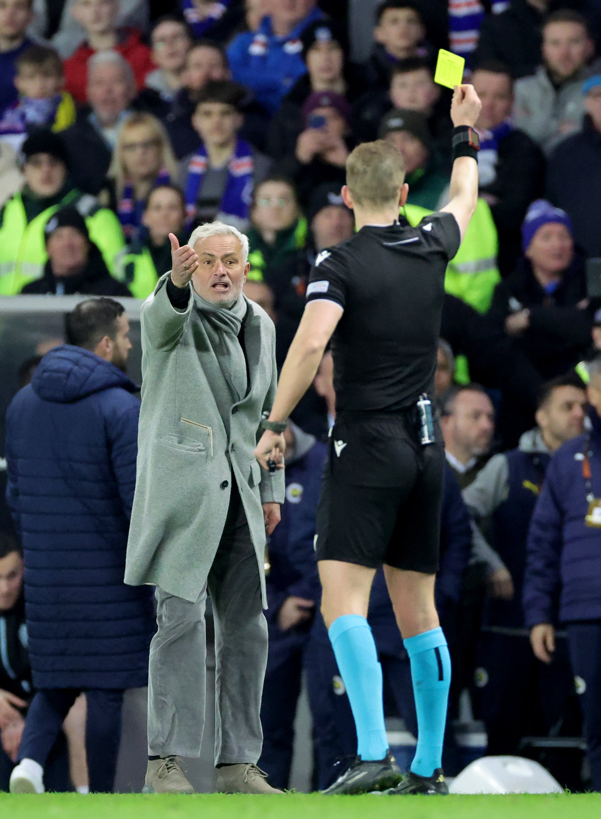 Fenerbahce manager Jose Mourinho (left) is shown a yellow card by referee Espen Eskas