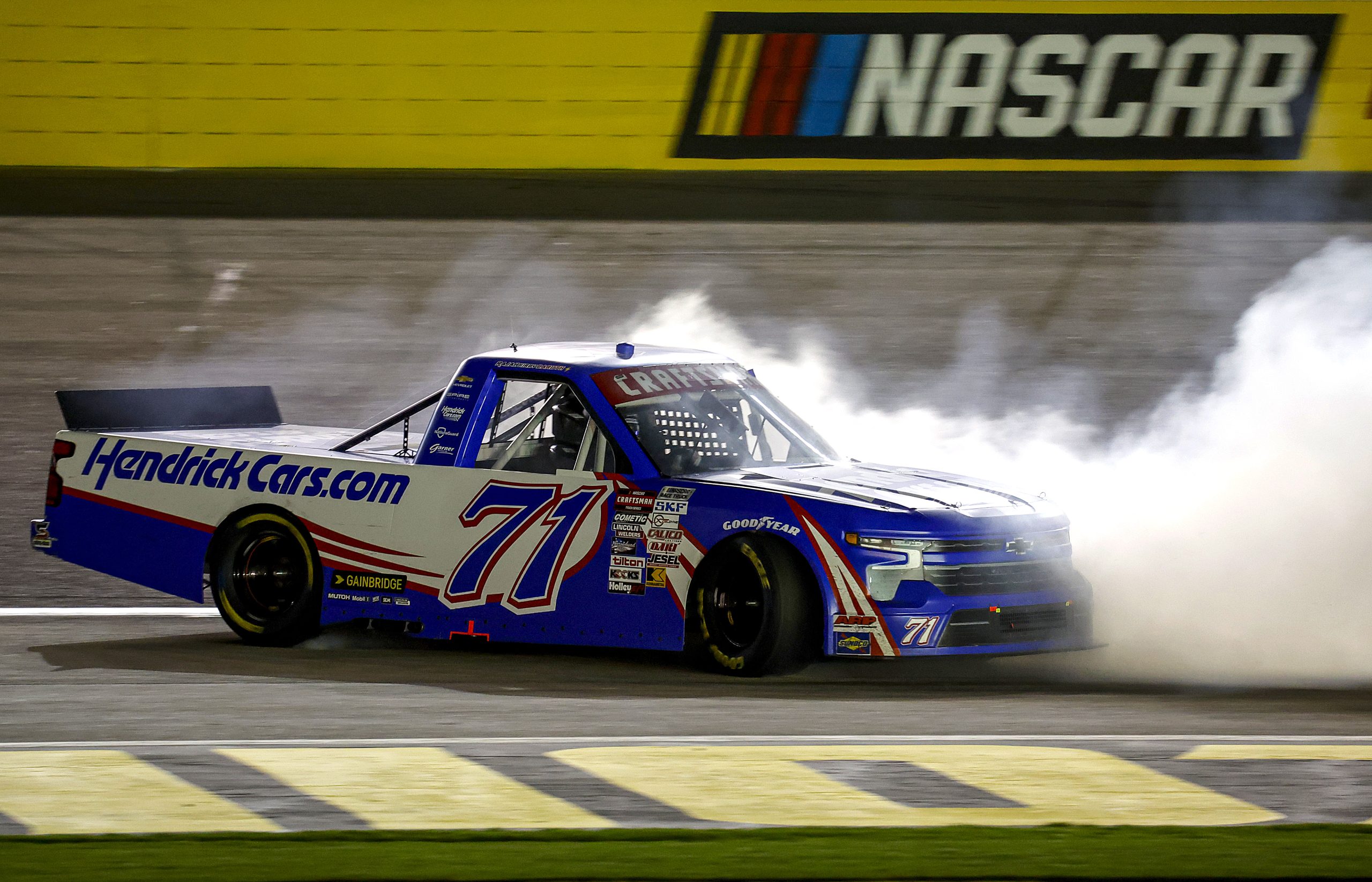 LAS VEGAS, NEVADA - MARCH 01: Rajah Caruth, driver of the #71 HendrickCars.com Chevrolet, celebrates with a burnout after winning the NASCAR Craftsman Truck Series Victoria