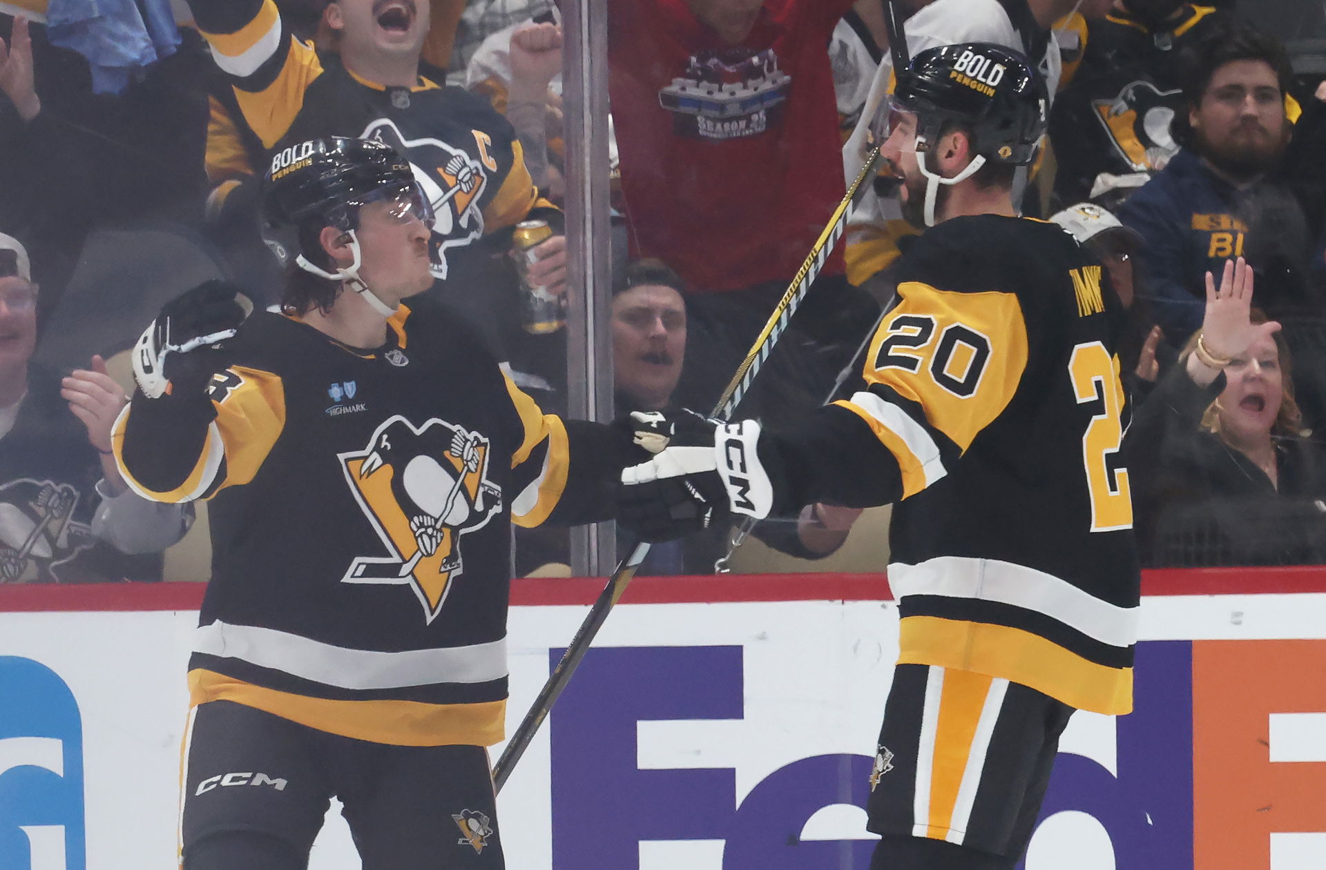 Mar 13, 2025; Pittsburgh, Pennsylvania, USA; Pittsburgh Penguins left wing Danton Heinen (left) and defenseman Conor Timmins (20) celebrate a goal by Timmins against the St. Louis Blues during the second period at PPG Paints Arena. (Charles LeClaire-Imagn Images)