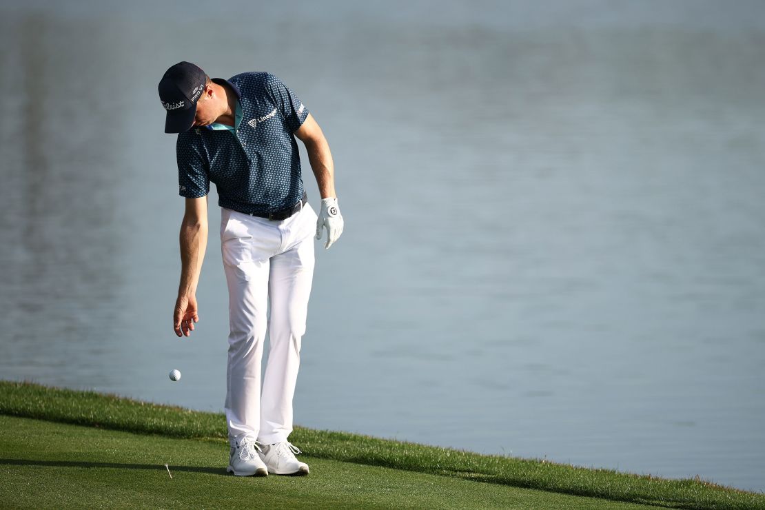 Thomas takes a drop after finding the water at the 18th hole.