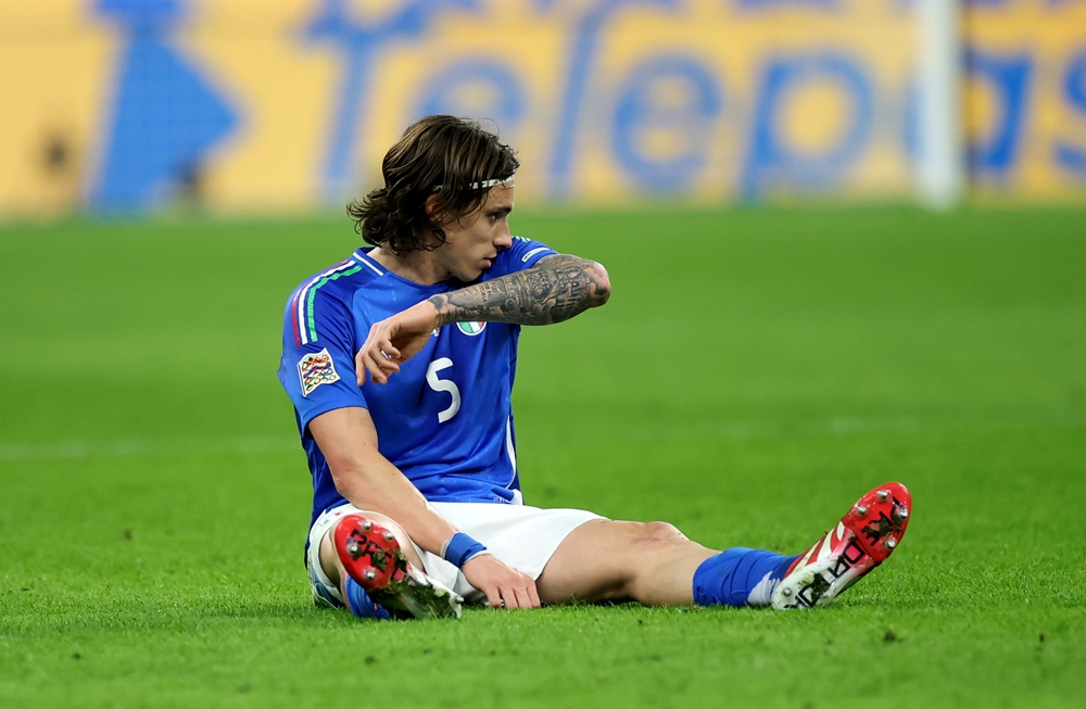 MILAN, ITALY: Riccardo Calafiori of Italy goes down with an injury during the UEFA Nations League quarterfinal leg one match between Italy and Germany at Stadio San Siro on March 20, 2025. (Photo by Alex Grimm/Getty Images)