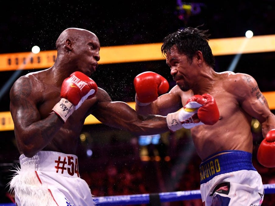 Pacquiao (right) during his points loss to Yordenis Ugas in 2021