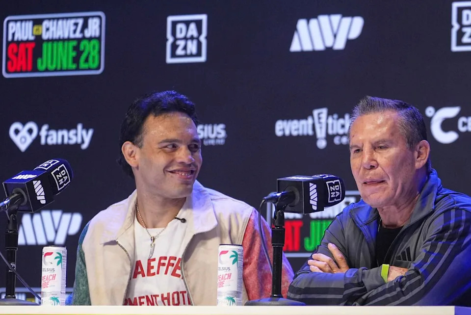 Boxers Julio César Chávez Jr. and his father, Julio César Chávez Sr., sit beside each other during a news conference.