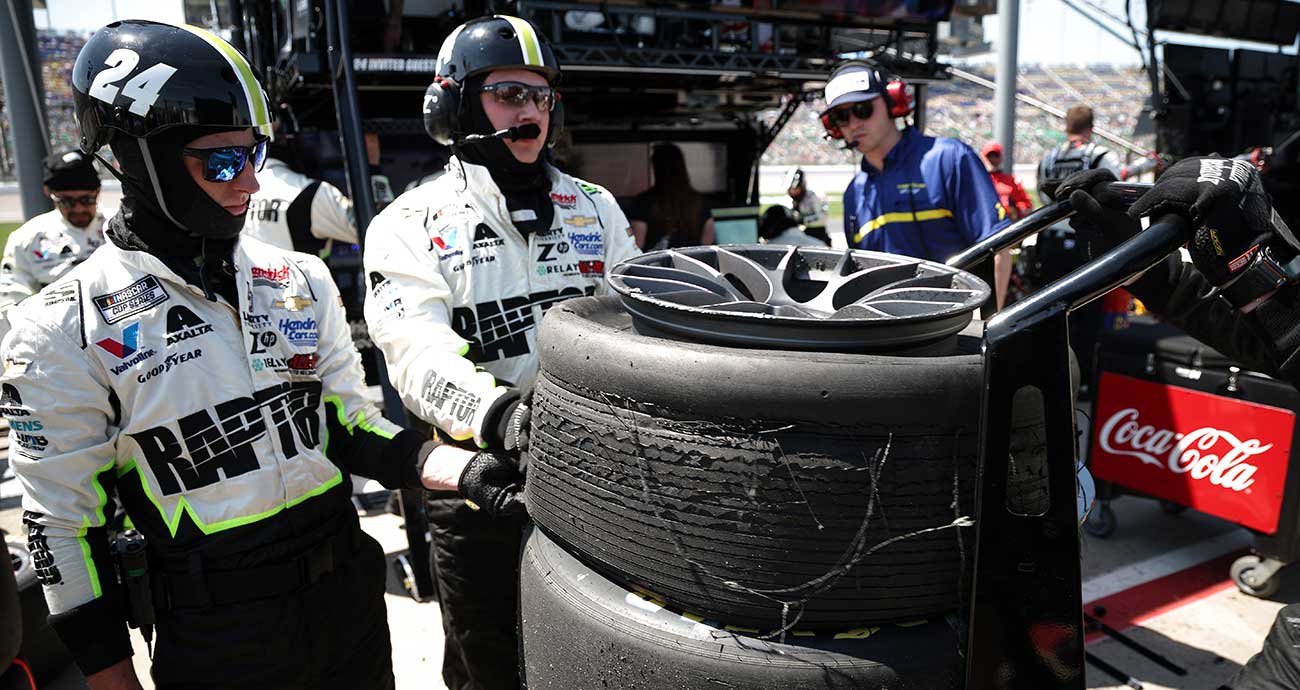No. 24 crewmembers check over a shredded tire from William Byron