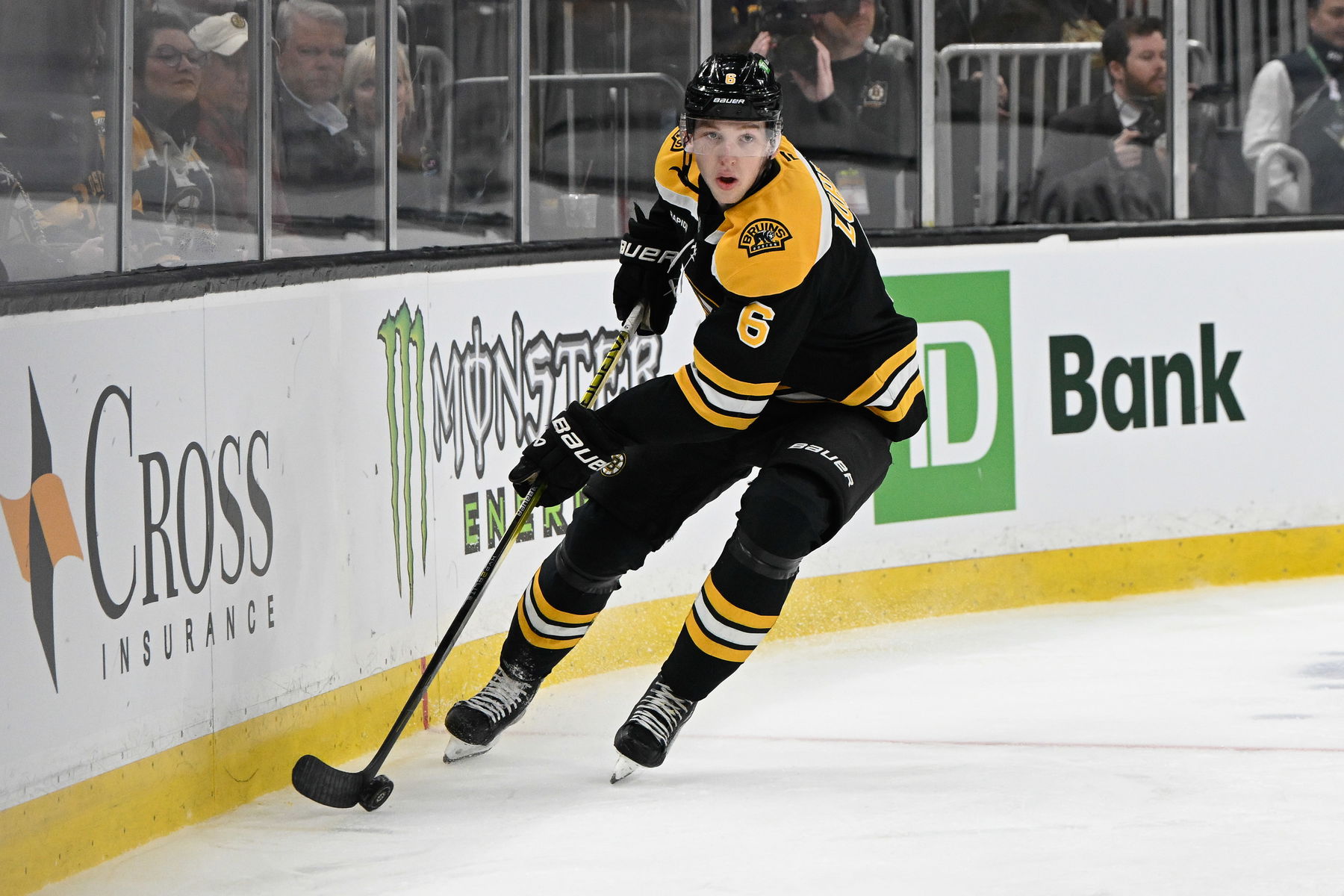 Mar 15, 2025; Boston, Massachusetts, USA; Boston Bruins defenseman Mason Lohrei (6) with the puck during the second period against the Tampa Bay Lightning at TD Garden. (Eric Canha-Imagn Images)
