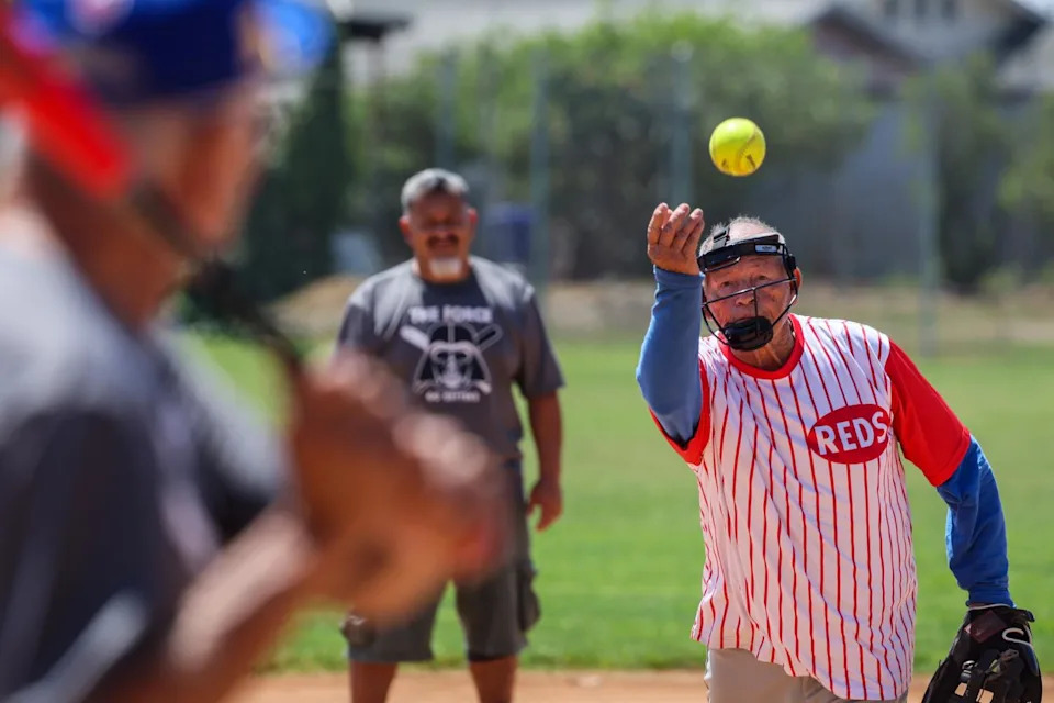 A pitcher tosses to a batter.
