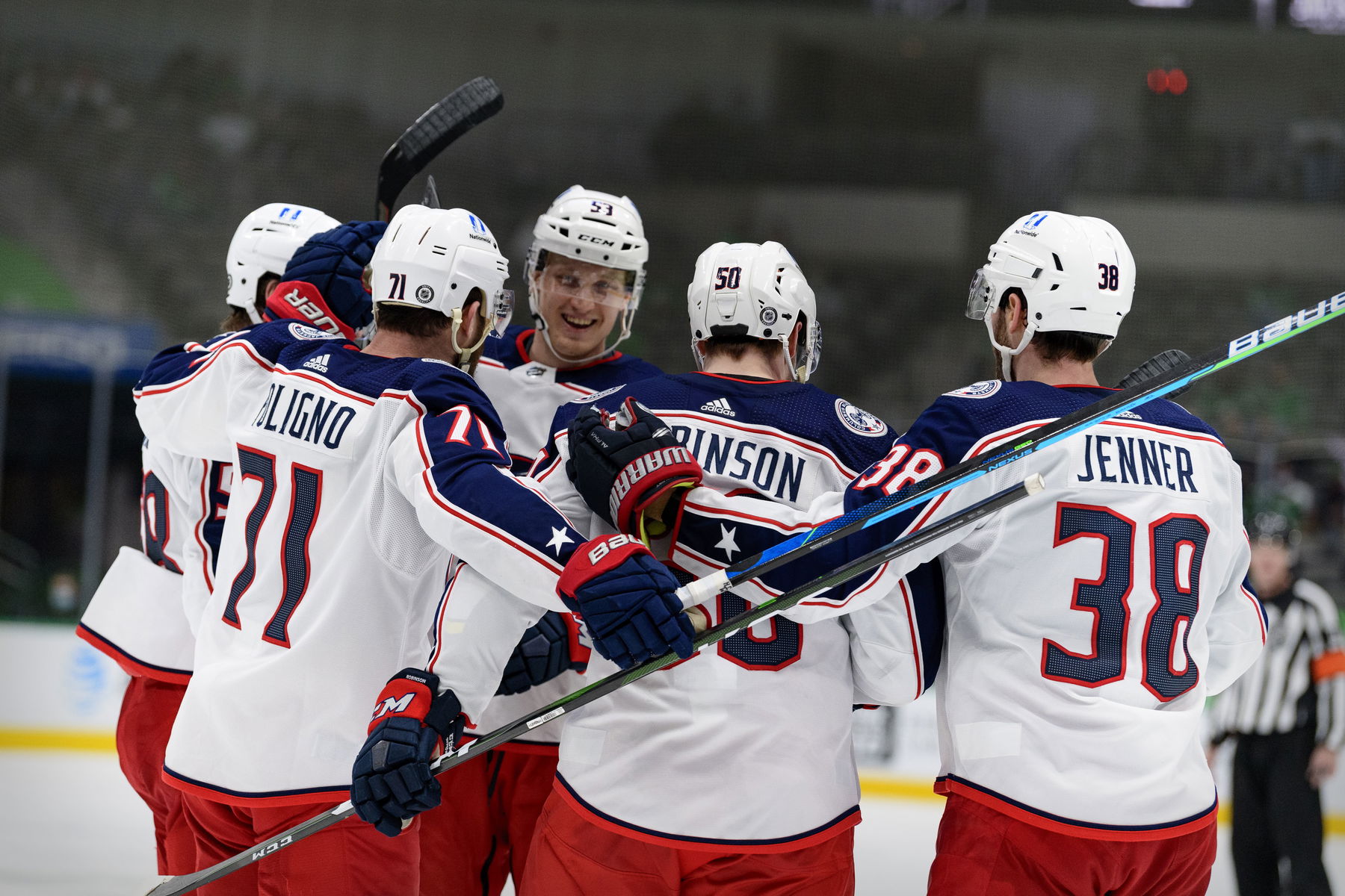 Mar 4, 2021; Dallas, Texas, USA; Columbus Blue Jackets left wing Nick Foligno (71) and left wing Eric Robinson (50) and center Boone Jenner (38) and defenseman Gabriel Carlsson (53) celebrate a goal scored against the Dallas Stars during the third period at the American Airlines Center. (Jerome Miron-Imagn Images)