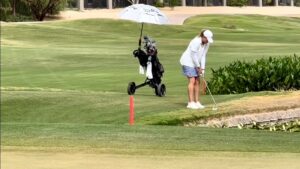 Pro golfer holes out for eagle swinging her golf club upside down