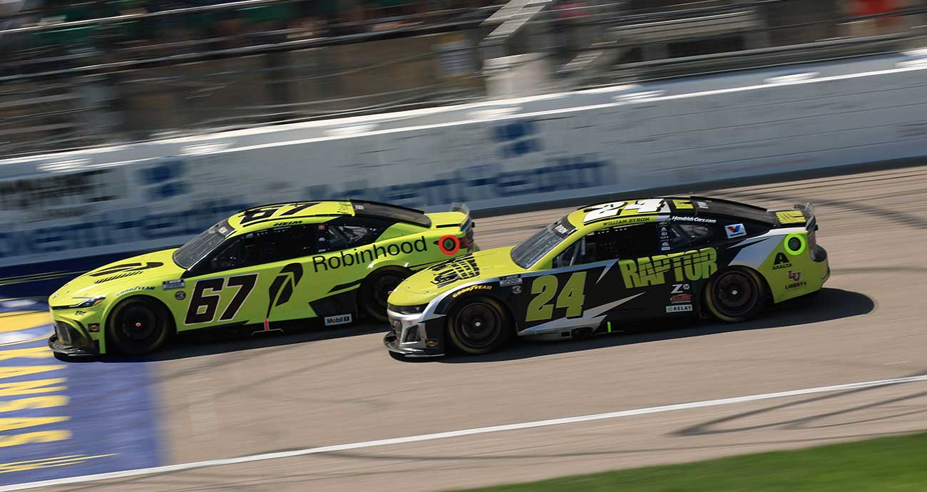 Corey Heim (67) races with William Byron on the frontstretch at Kansas Speedway