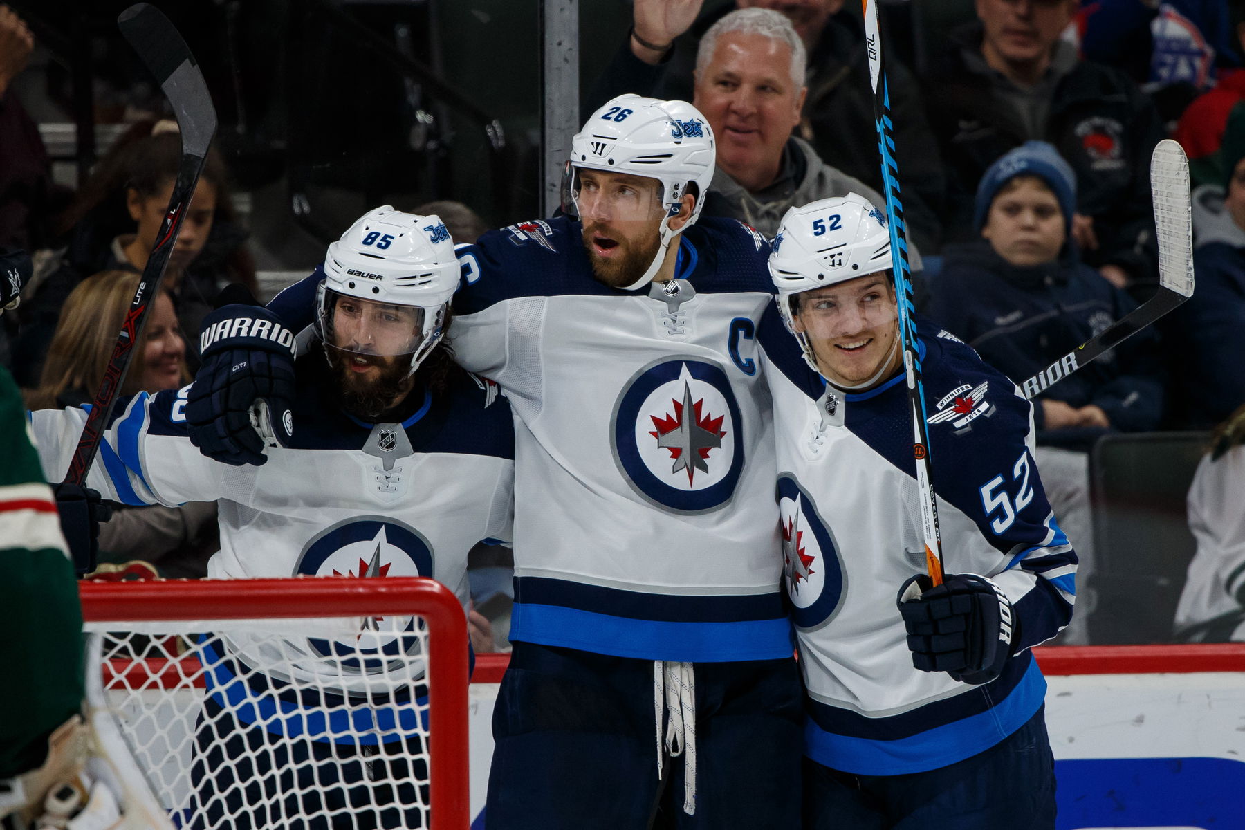 Jan 13, 2018; Saint Paul, MN, USA; Winnipeg Jets forward Mathieu Perreault (85) celebrates his goal with forward Blake Wheeler (26) and forward Jack Roslovic (52) against the Minnesota Wild at Xcel Energy Center. (Brad Rempel-Imagn Images)