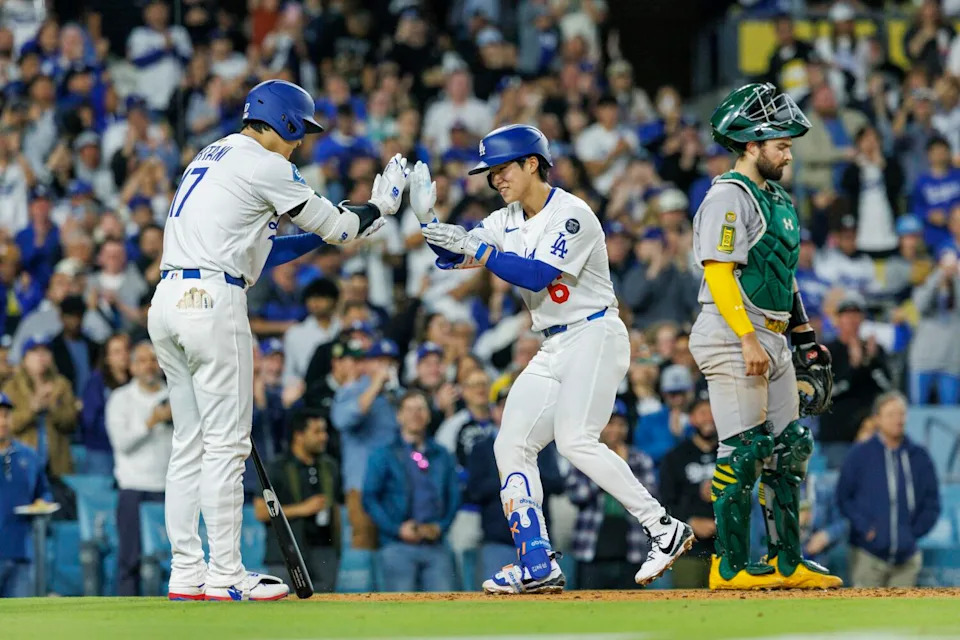 Hyeseong Kim, right, celebrates with Shohei Ohtani after hitting his first career home run in the Dodgers' win Wednesday.
