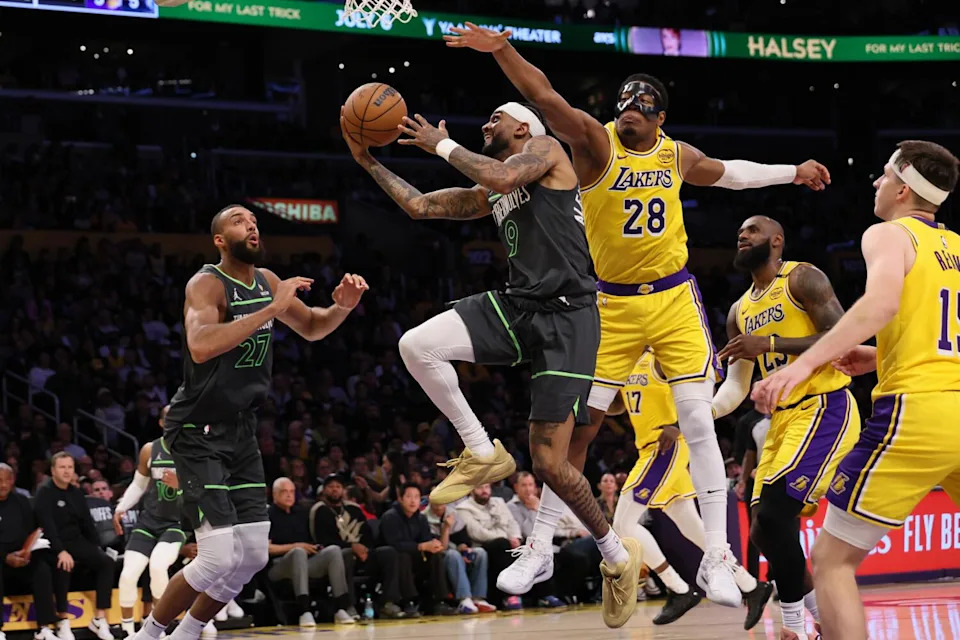 Timberwolves guard Nickeil Alexander-Walker drives past Lakers forward LeBron James and his teammates late in Game 5