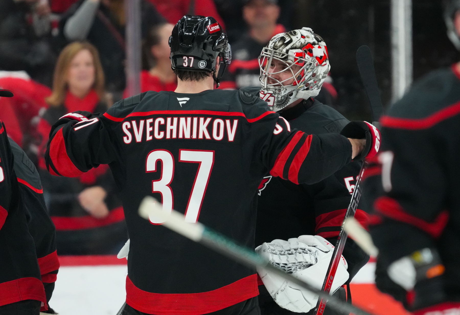 Dec 17, 2024; Raleigh, North Carolina, USA; Carolina Hurricanes right wing Andrei Svechnikov (37) and goaltender Pyotr Kochetkov (52) celebrate their victory against the New York Islanders at Lenovo Center. (James Guillory-Imagn Images)