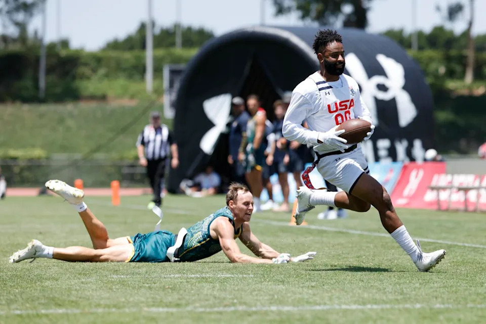 U.S. wide receiver Ja'Deion High evades an Australian defender.