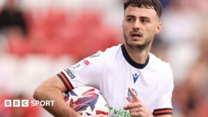 Aaron Collins: MK Dons sign Bolton Wanderers striker for undisclosed fee