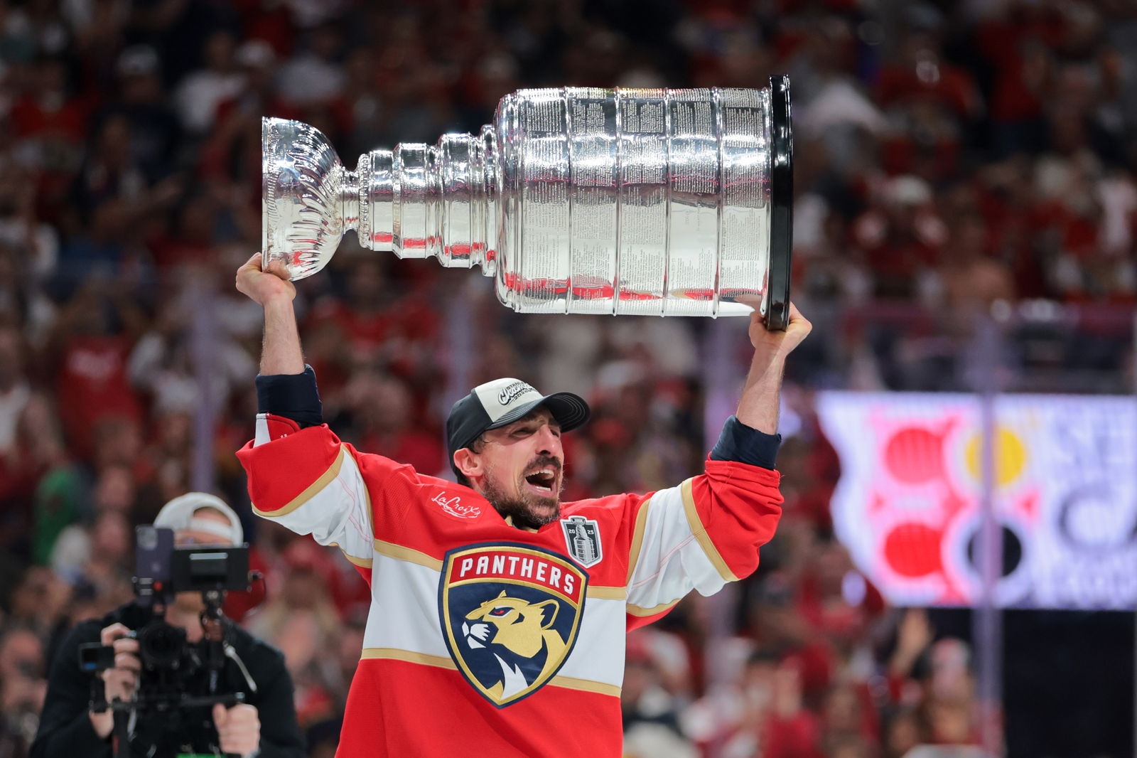 Jun 17, 2025; Sunrise, Florida, USA; Florida Panthers center Brad Marchand (63) hoists the Stanley Cup after winning game six of the 2025 Stanley Cup Final against the Edmonton Oilers at Amerant Bank Arena. Mandatory Credit: Sam Navarro-Imagn Images