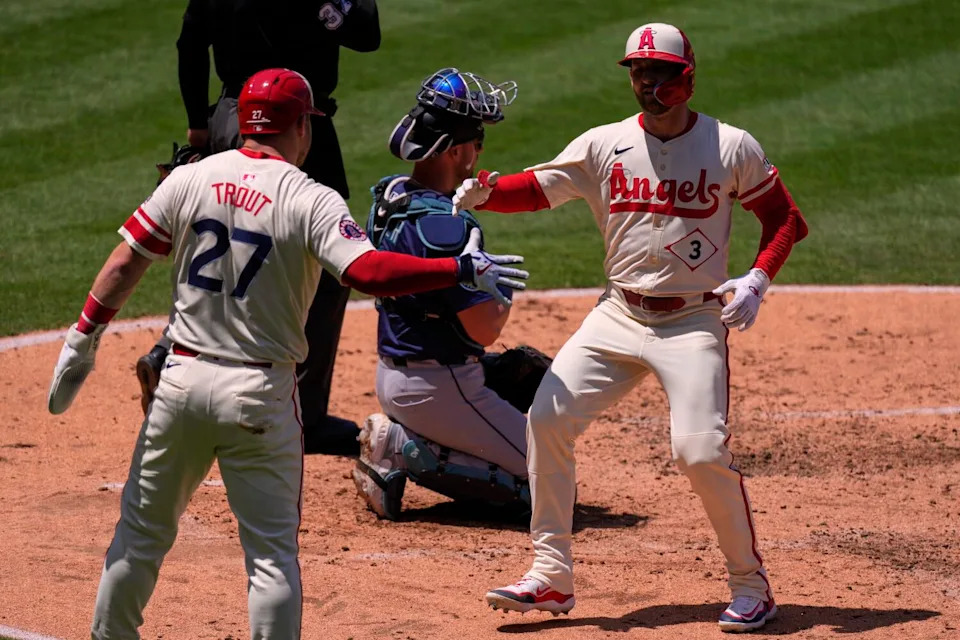 Taylor Ward, right, is congratulated by Mike Trout, left, after hitting a two-run home run.