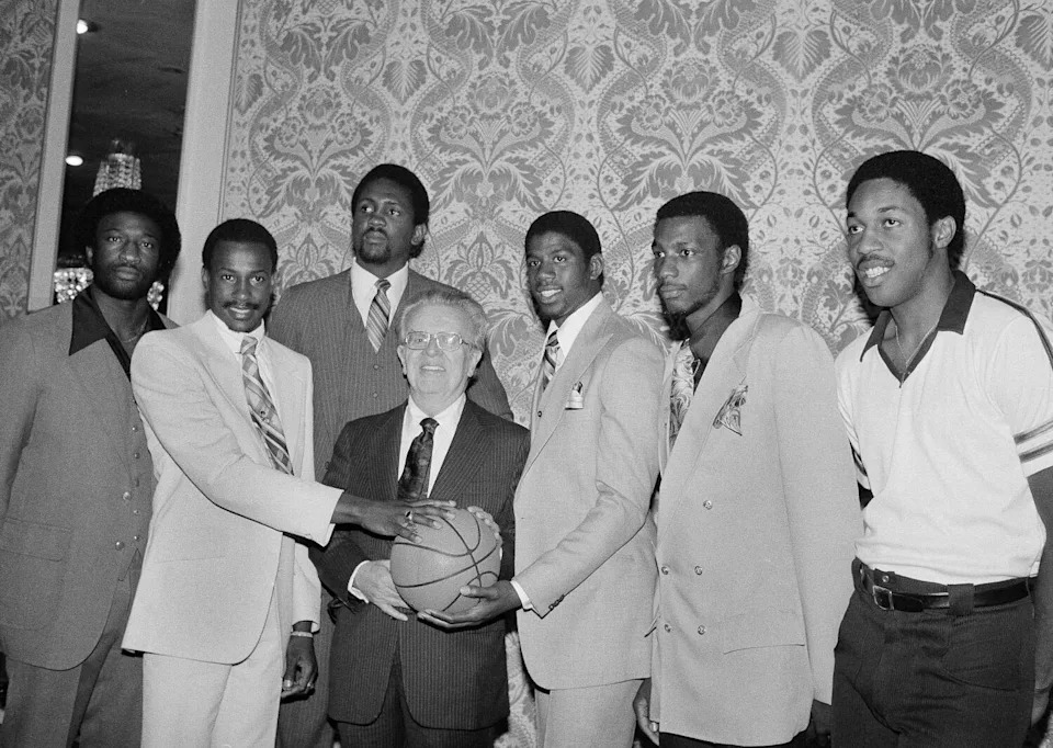 College athletes selected in the national basketball association's draft pose with NBA commissioner Larry O'Brien.