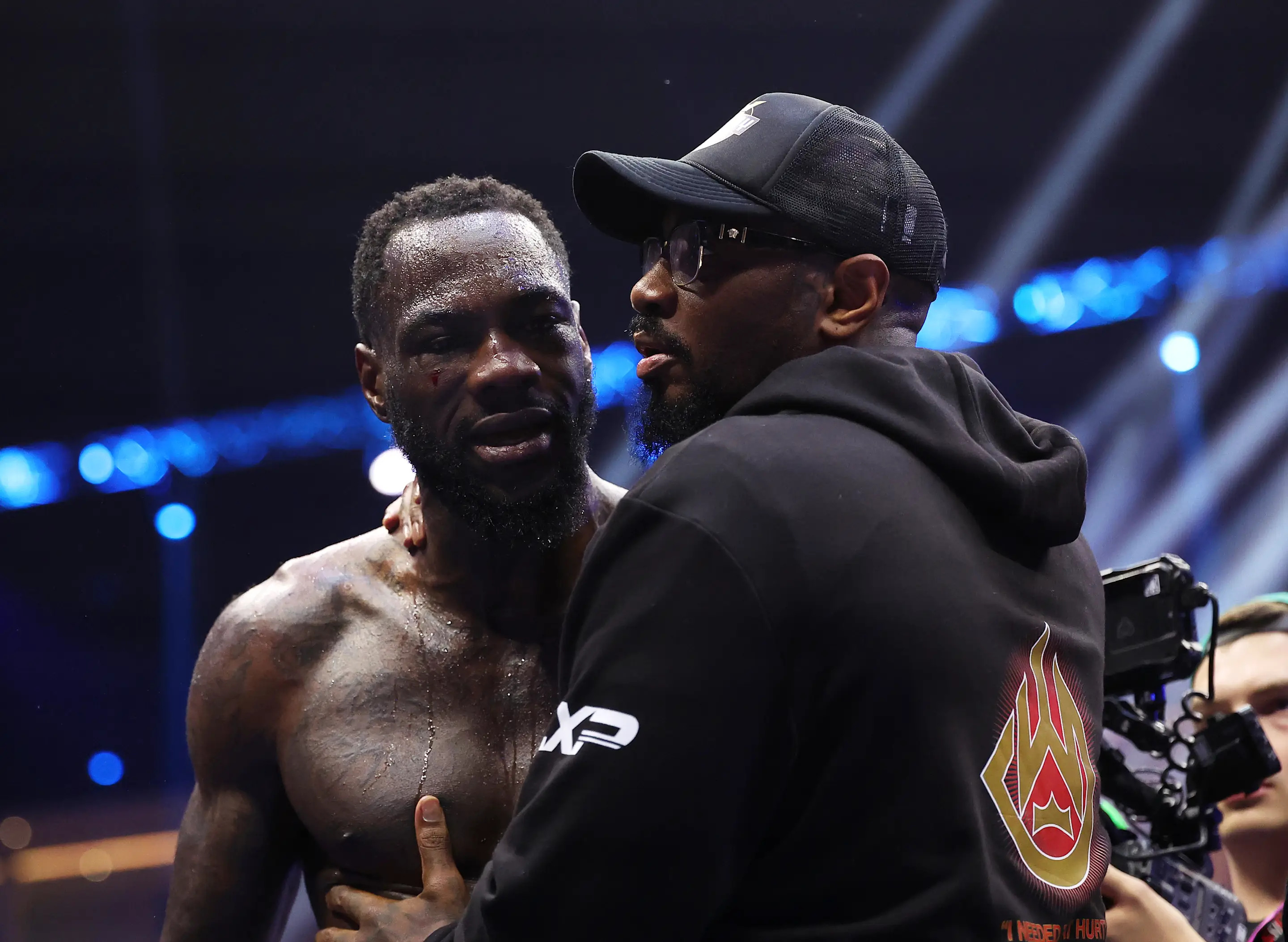 RIYADH, SAUDI ARABIA - JUNE 01: Deontay Wilder of Team Matchroom is embraced by trainer Malik Scott after being knocked down by Zhilei Zhang of Team Queensberry during the Heavyweight fight between Deontay Wilder of Team Matchroom and Zhilei Zhang of Team Queensberry on the 5v5: Queensberry v Matchroom Fight Night card at Kingdom Arena on June 01, 2024 in Riyadh, Saudi Arabia. (Photo by Richard Pelham/Getty Images)