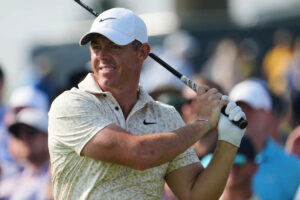 A frustrated McIlroy smashes a US Open tee marker but makes it to the weekend anyway