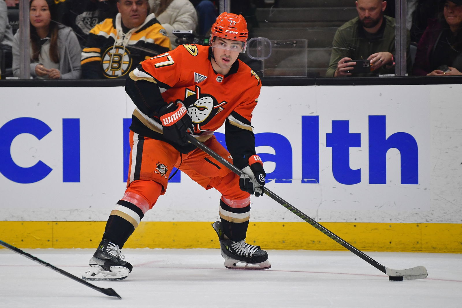 Mar 26, 2025; Anaheim, California, USA; Anaheim Ducks right wing Frank Vatrano (77) controls the puck against the Boston Bruins during the second period at Honda Center. Mandatory Credit: Gary A. Vasquez-Imagn Images