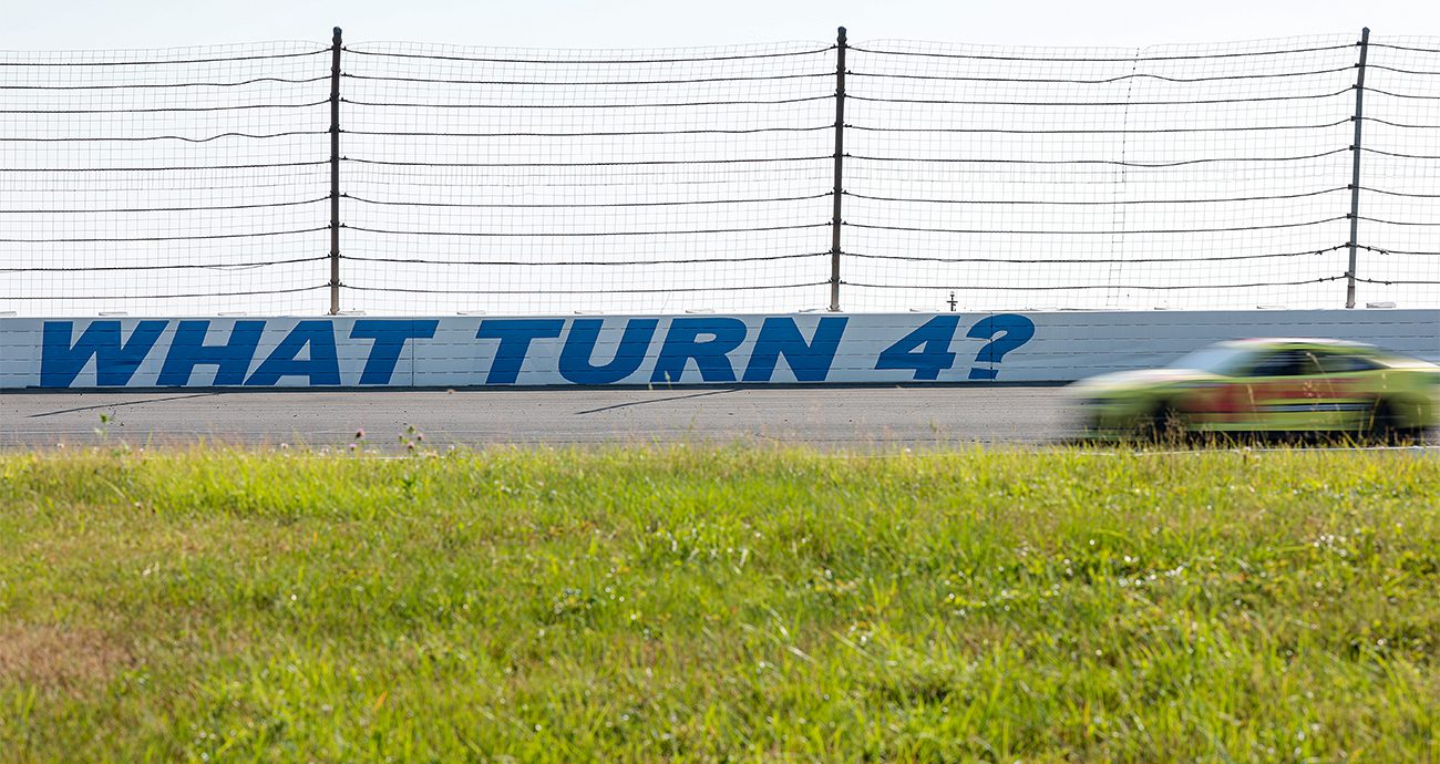 car drives in front of what turn 4 sign at pocono