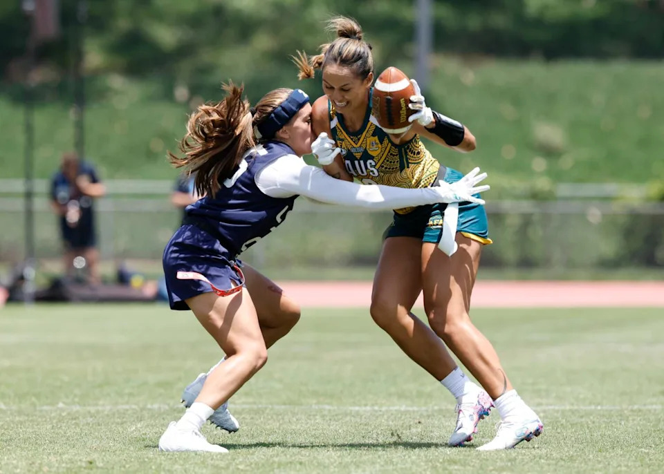 U.S. defensive back Laneah Bryan, left, tries to pull a flag off an Australian player.