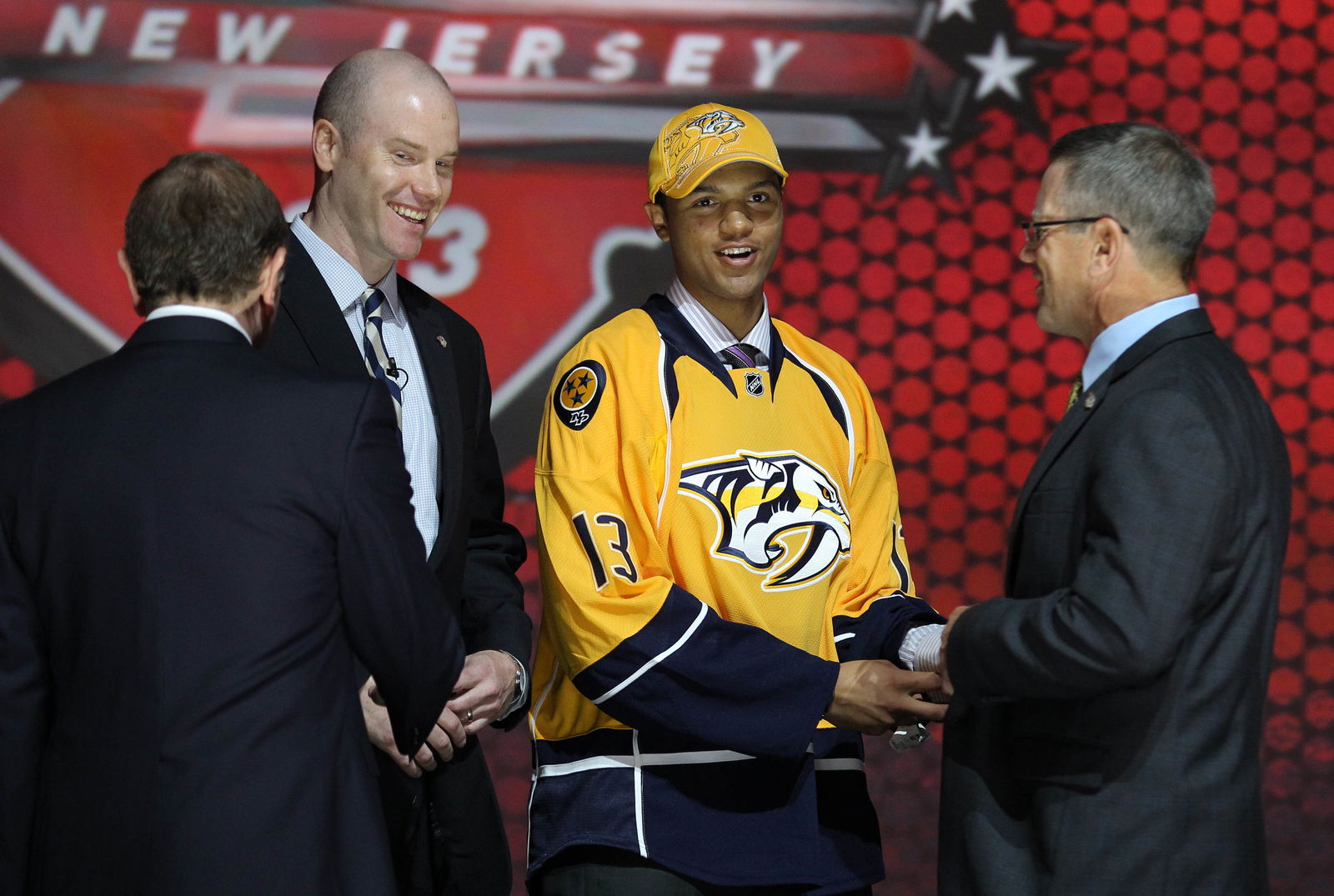 Jun 30, 2013; Newark, NJ, USA; Seth Jones reacts on stage after being introduced as the number four overall pick to the Nashville Predators during the 2013 NHL Draft at the Prudential Center. Mandatory Credit: Ed Mulholland-Imagn Images