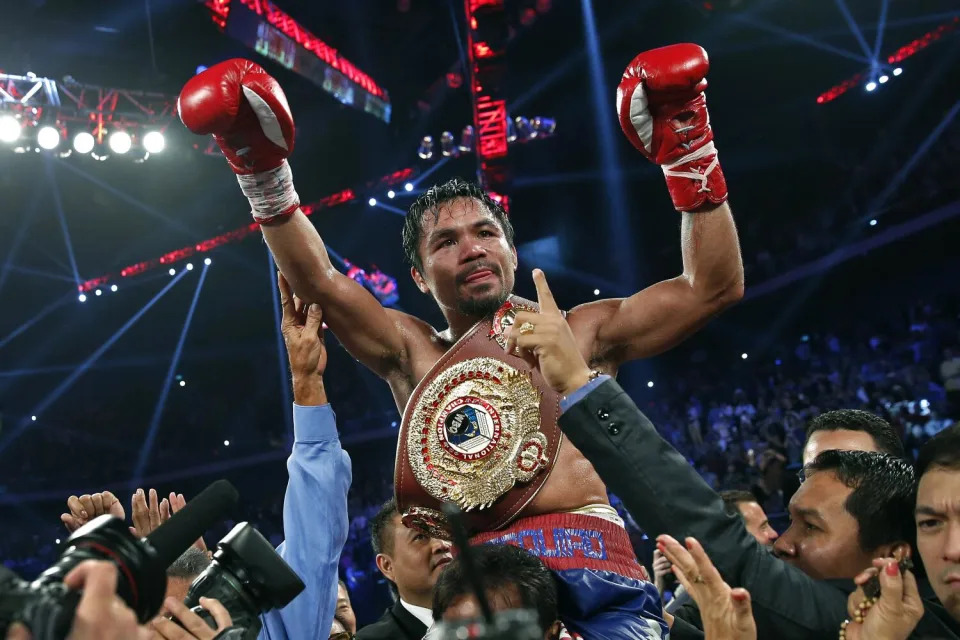 Manny Pacquiao from the Philippines wears the champion's belt after defeating Brandon Rios.