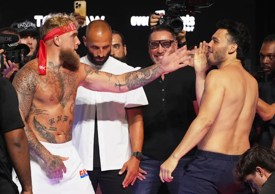 Jake Paul, left, and Julio César Chávez Jr. taunt each other following a weigh-in ahead of their boxing match