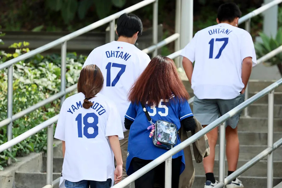 Fans head up stairs wearing Ohtani and Yamamoto jerseys before the game against the Detroit Tigers.