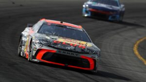 Chase Briscoe holds off Denny Hamlin to win at Pocono Raceway with impressive fuel mileage