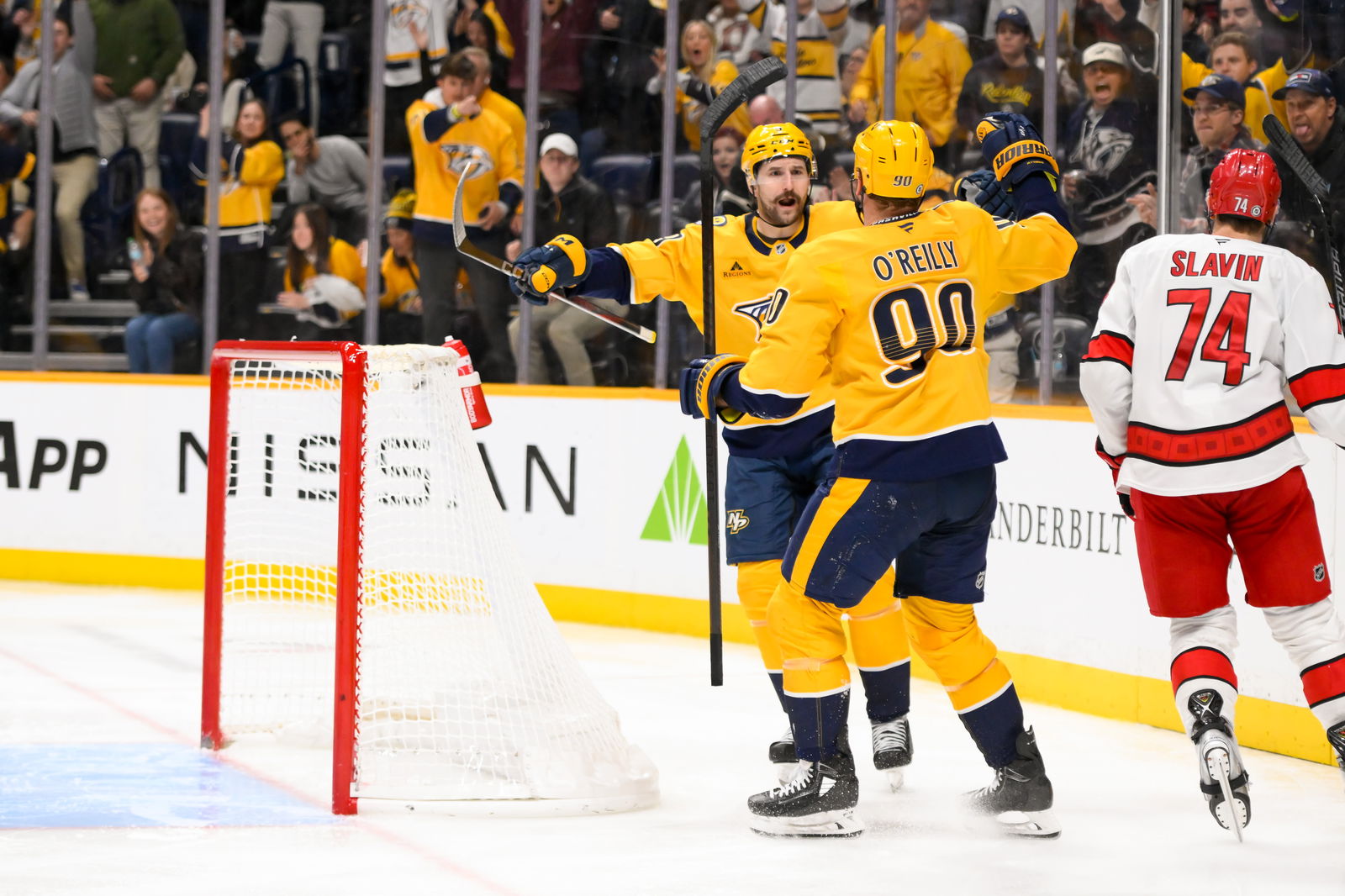 Dec 23, 2024; Nashville, Tennessee, USA; Nashville Predators center Ryan O'Reilly (90) celebrates his goal with left wing Filip Forsberg (9) against the Carolina Hurricanes during the third period at Bridgestone Arena. Mandatory Credit: Steve Roberts-Imagn Images