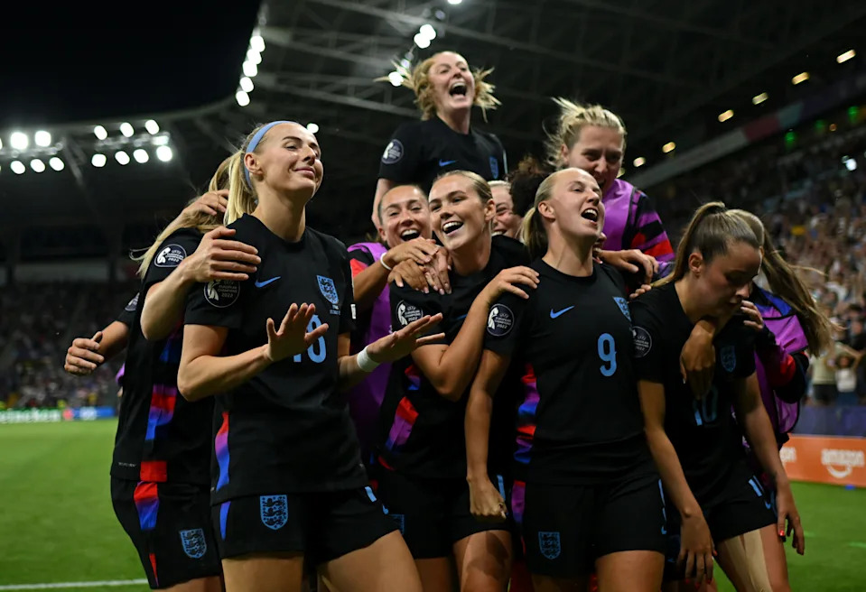 Chloe Kelly (L) celebrates with her teammates after scoring the game-winner. (Harriet Lander/The FA via Getty Images)