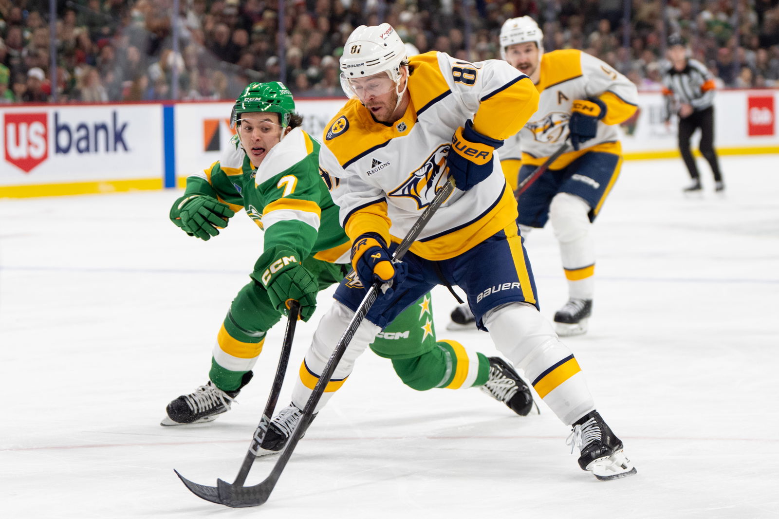 Dec. 31, 2024; Saint Paul, Minnesota, USA; Minnesota Wild defenseman Brock Faber (7) defends Nashville Predators center Jonathan Marchessault (81) in the first period at Xcel Energy Center. Mandatory Credit: Matt Blewett-Imagn Images