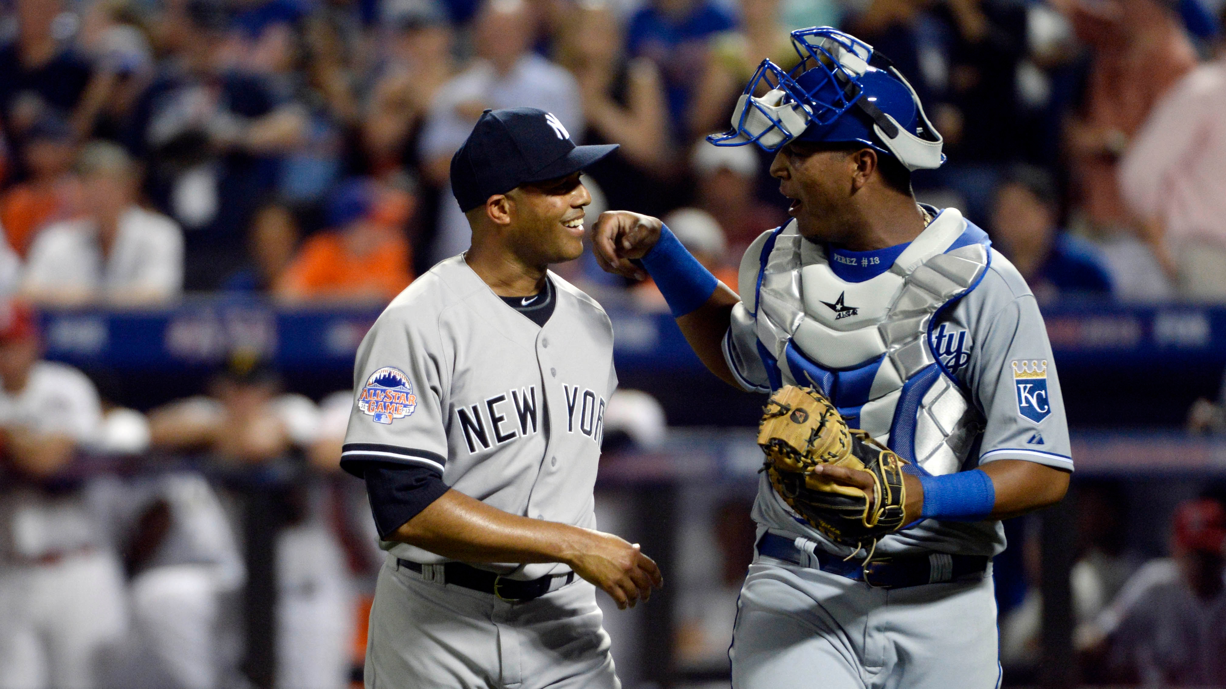 American League pitcher Mariano Rivera (42) of the New York Yankees walks off the field with catcher Salvador Perez (13) of the Kansas City Royals after retiring the National League in the 8th inning.
