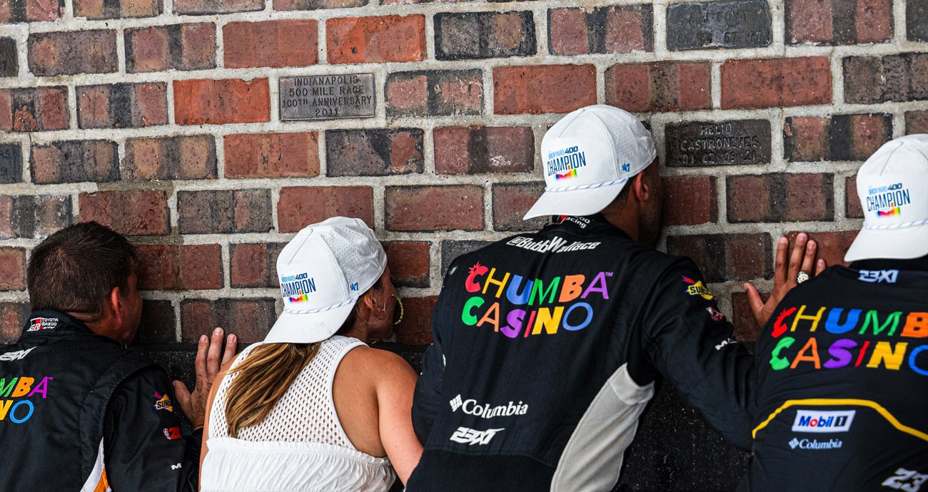 Bubba Wallace, wife Amanda, the No. 23 team kiss the bricks at Indianapolis.