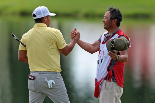 Kurt Kitayama of the United States reacts with his caddie Daniel Kitayama on the 18th green during the third round of the 3M Open 2025 at TPC Twin Cities on July 26, 2025 in Blaine, Minnesota. (Photo by Andrew Wevers/Getty Images)
