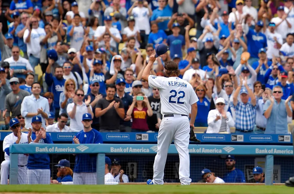 Clayton Kershaw tips his cap to fans after being taken out in the fourth inning of a baseball game against the Padres.