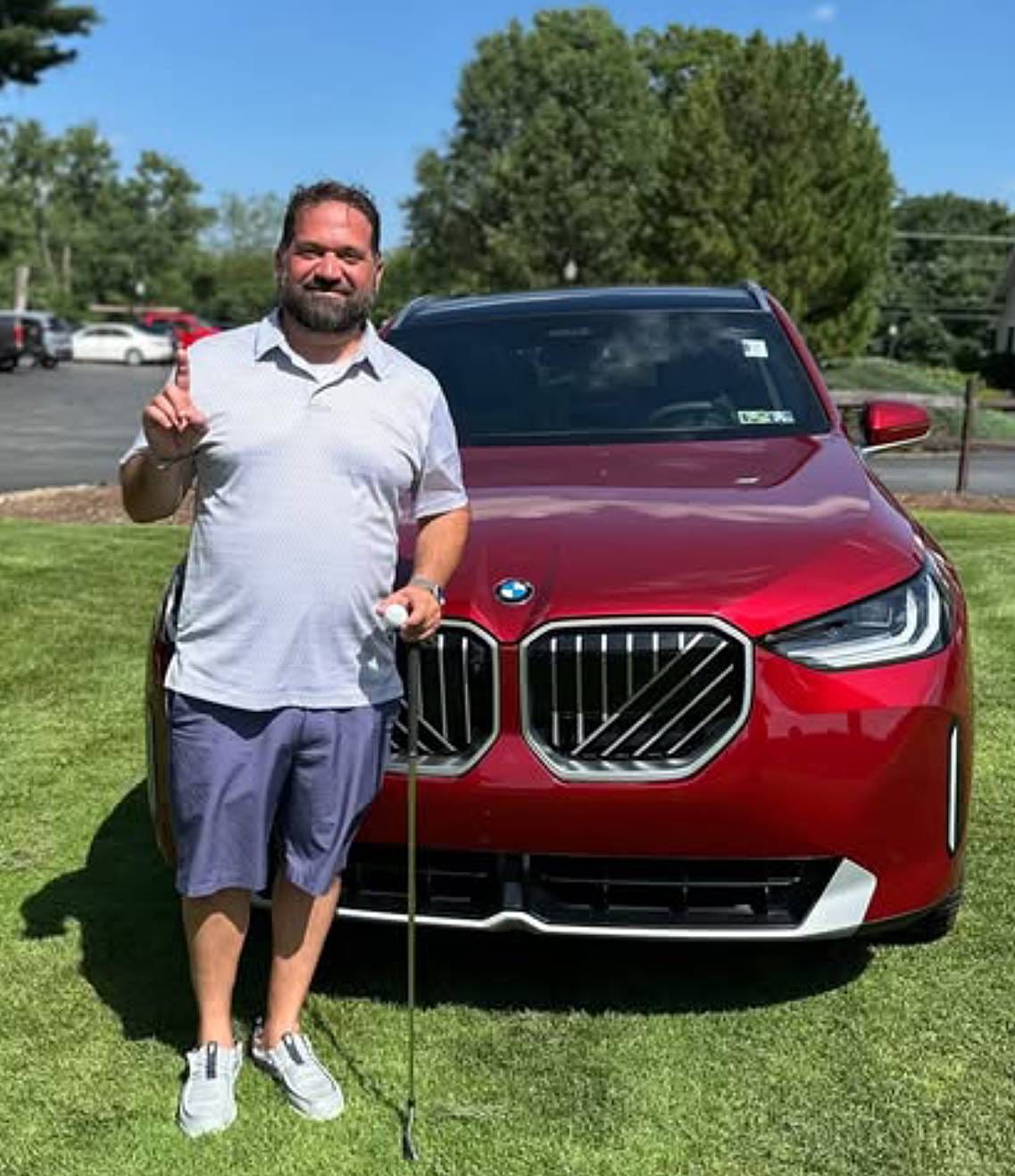 Jason Bish poses with the BMW he won by recording a hole in one during Mercyhurst Prep's Green & White Classic golf tournament on June 23 at Venango Valley Inn & Golf Club. Bish won the car when he aced the course's par-3, 197-yard 16th hole.