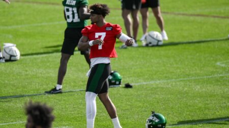 Justin Fields jogging on the practice field one day after toe injury