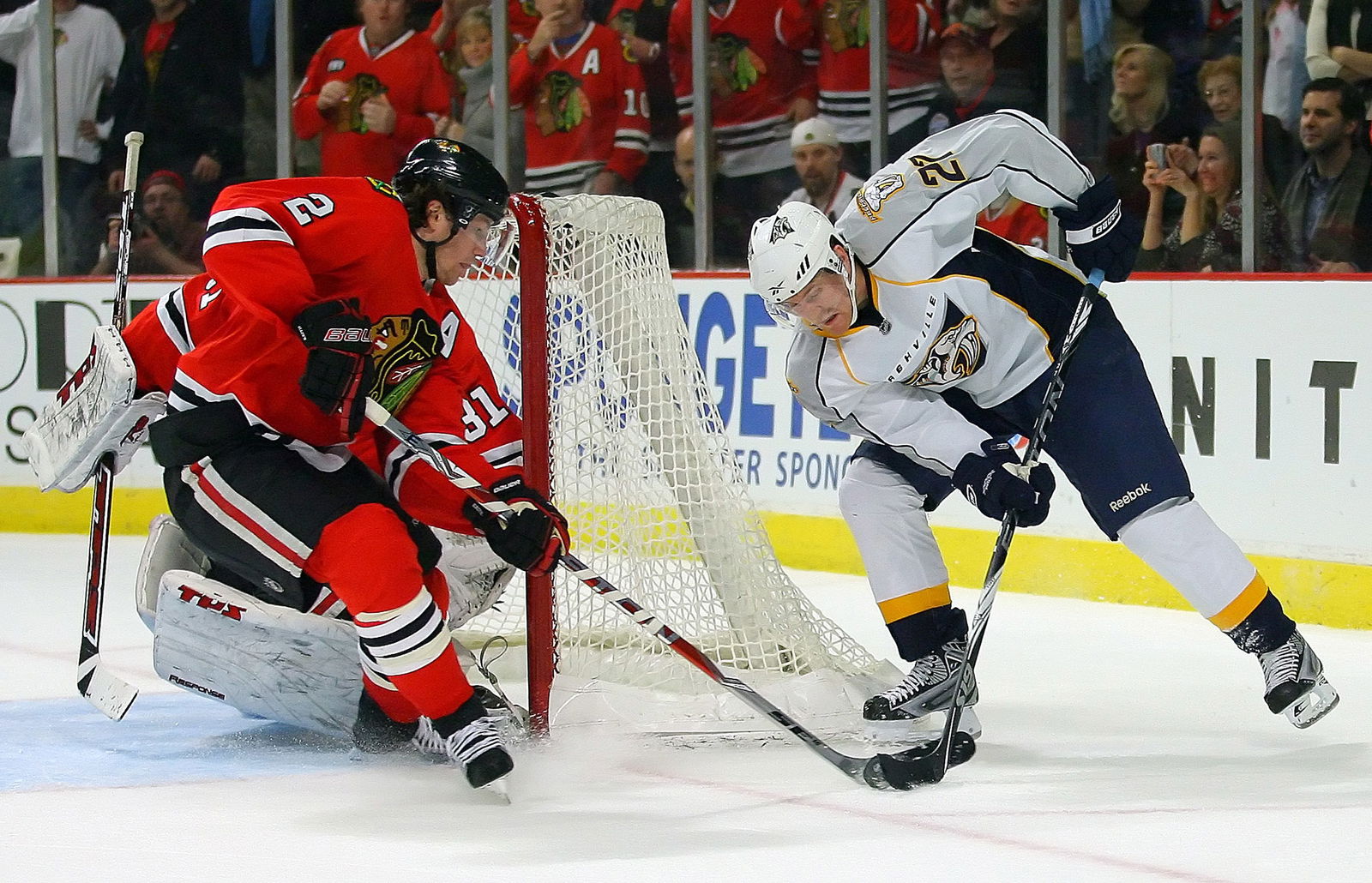 Dec 27, 2009; Chicago, IL, USA; Nashville Predators right wing Patric Hornqvist (27) attempts a wrap around the net while he is defended by Chicago Blackhawks defenseman Duncan Keith (2) during the third period at the United Center. The Blackhawks defeated the Predators 5-4. Mandatory Credit: Dennis Wierzbicki-Imagn Images
