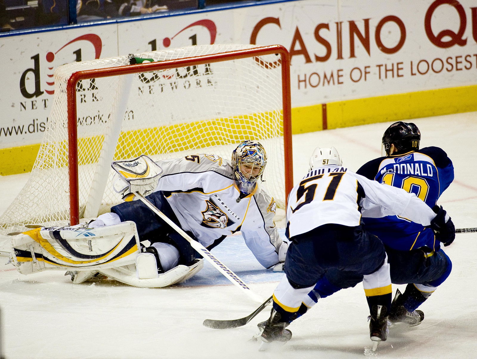 Dec 29, 2009; St. Louis, MO, USA; Nashville Predators defenseman Francis Bouillon (51) hooks St. Louis Blues center Andy McDonald (10) as Predators goalie Pekka Rinne (35) makes the save during the third period at the Scottrade Center. Bouillon was given a penalty on the play. The Predators defeated the Blues 4-3. Mandatory Credit: Scott Rovak-Imagn Images