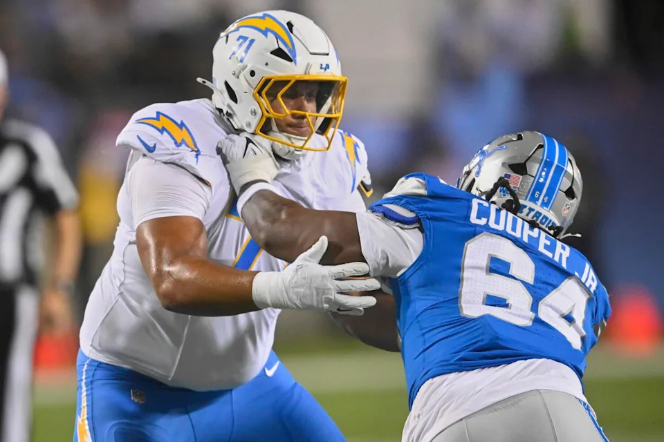 Chargers guard Branson Taylor, left, blocks Detroit Lions defensive end Keith Cooper Jr.
