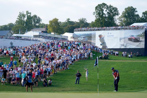 Bryson DeChambeau, bottom right, chips onto the 17th green during the final round of the BMW Championship golf tournament, Sunday, Aug. 29, 2021, at Caves Valley Golf Club in Owings Mills. (AP Photo/Julio Cortez)