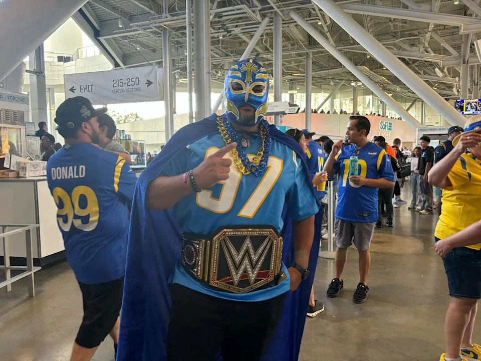 Chargers fan Angel Herrera poses for a photo at SoFi Stadium.